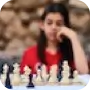 A girl sitting in front of a chess board thinking her next move